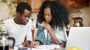 A woman and man are looking at papers.