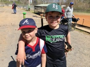 Two young boys are posing for a picture.