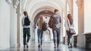 A group of people walking down the hall way