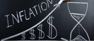 A chalkboard with the word inflation and dollar signs on it.