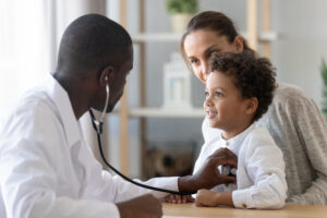 A doctor is examining a child 's lungs.